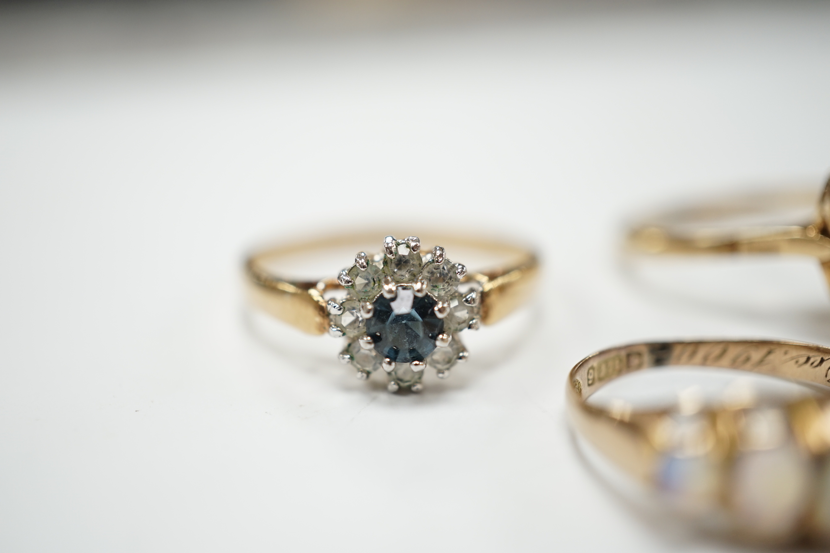 A late Victorian 9ct gold and graduated five stone opal set half hoop ring, size L, a 9ct, seed pearl and citrine cluster set flower head ring, gross 4.7 grams and a costume ring.